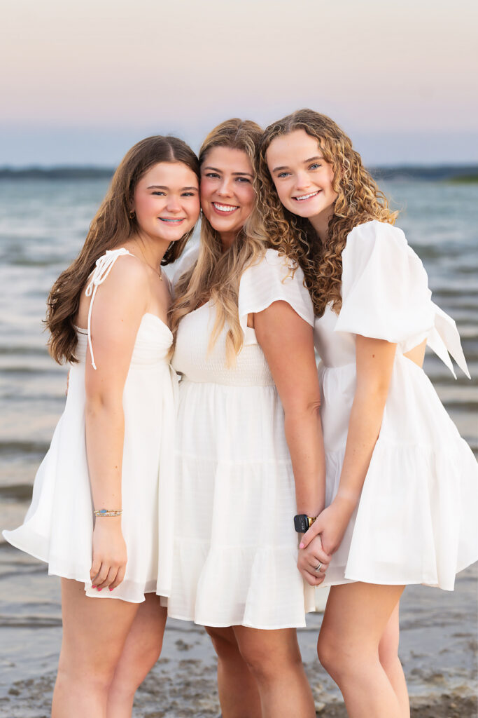 mom and daughters posing for a portrait by paige walker photography