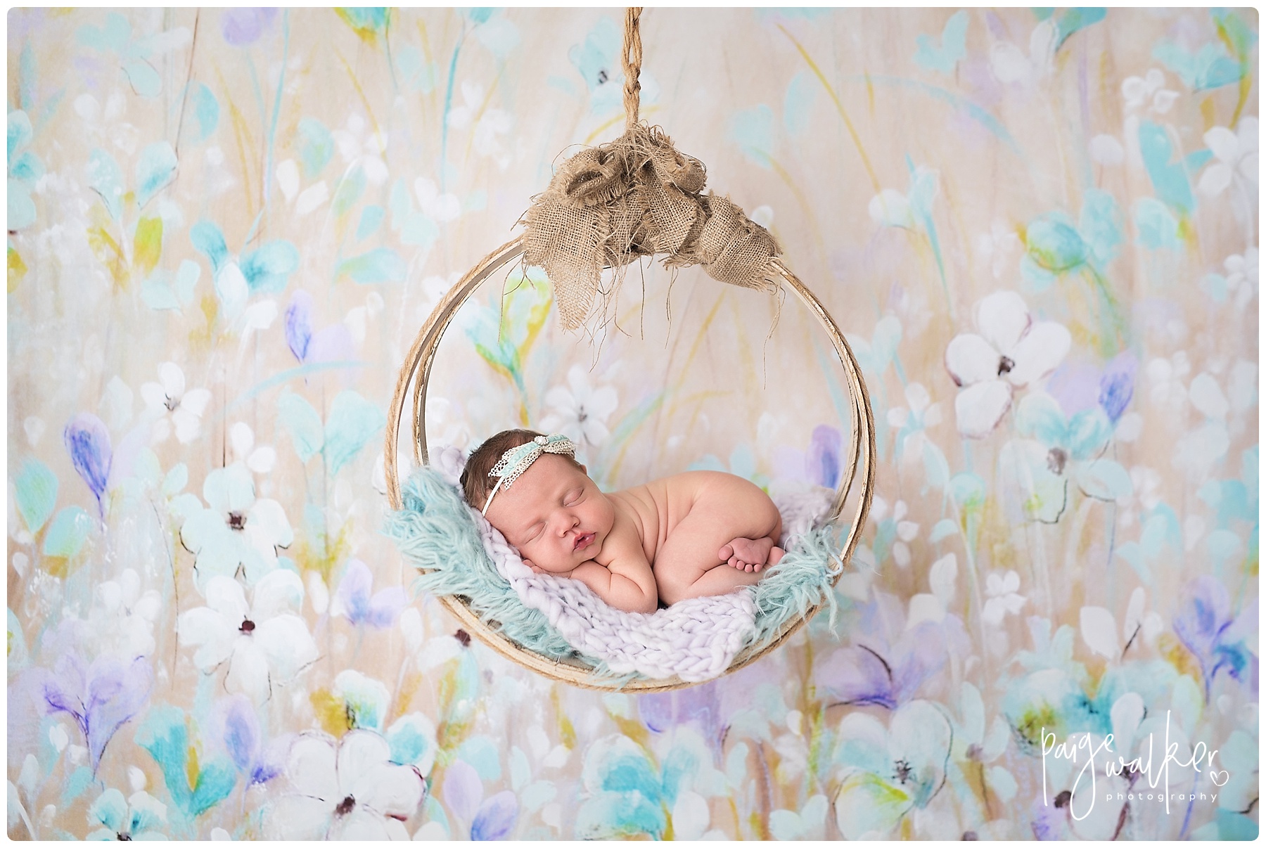 newborn girl hanging in a round swing