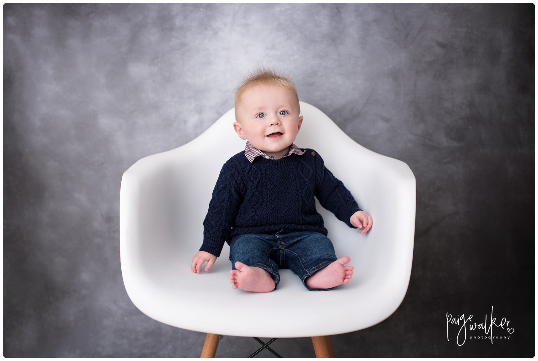 baby boy sitting in a white chair