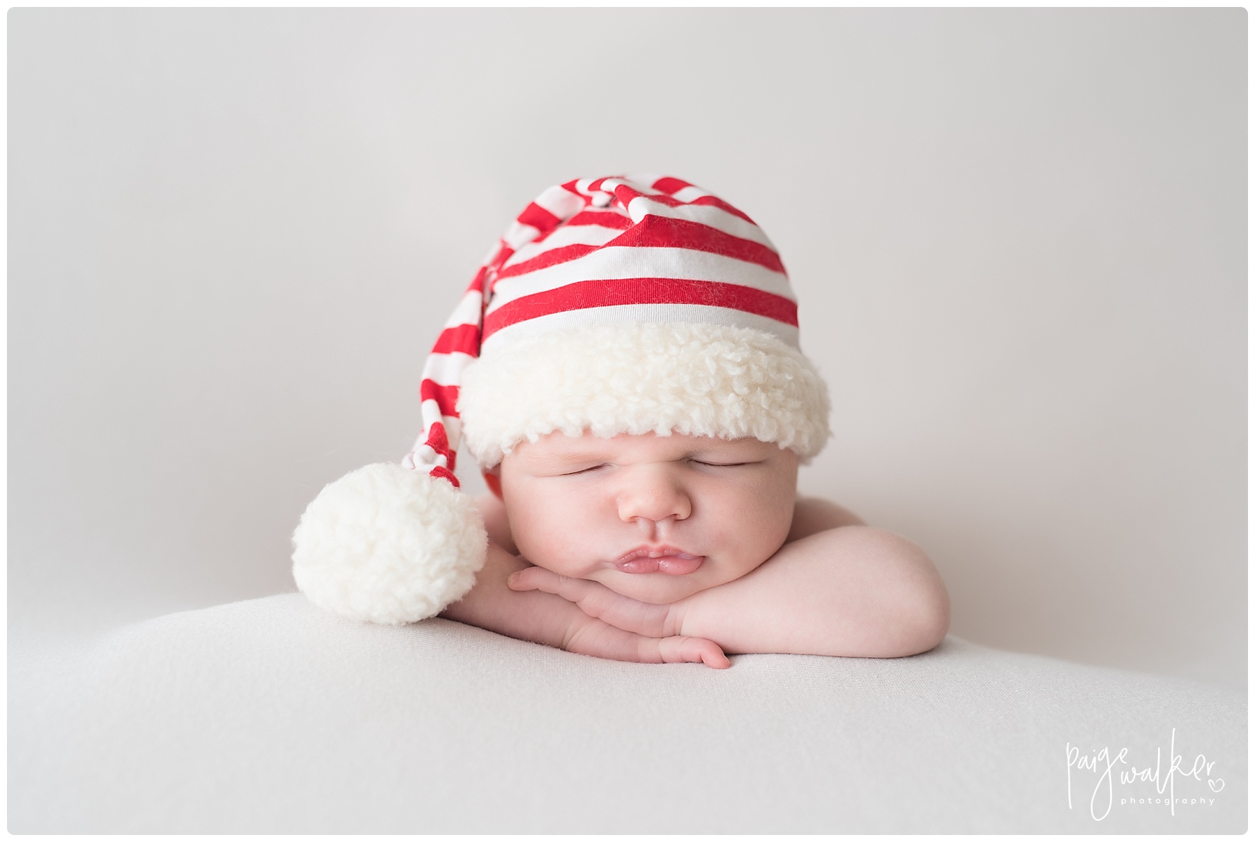 newborn boy with a Santa hat on