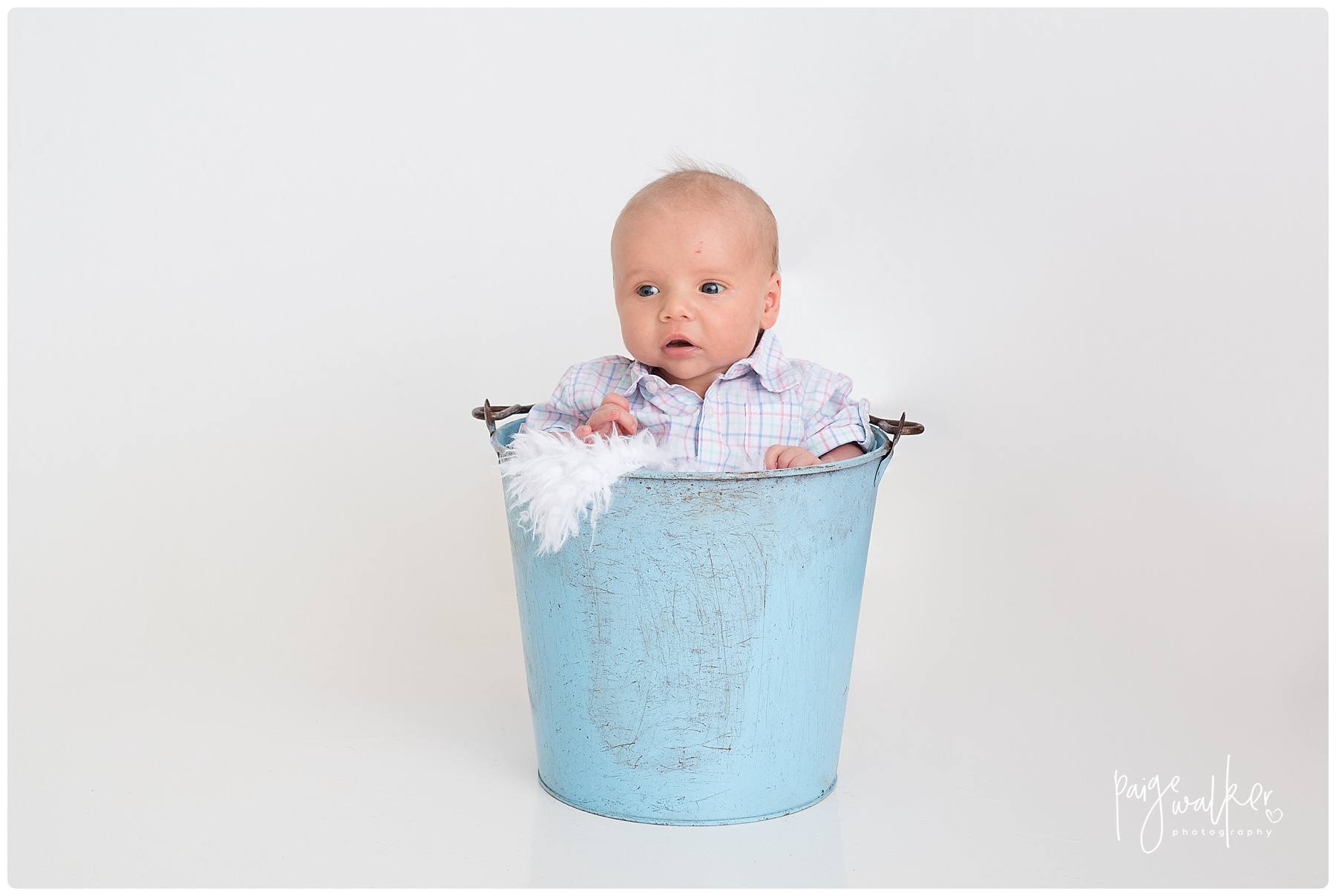 baby boy sitting in a bucket