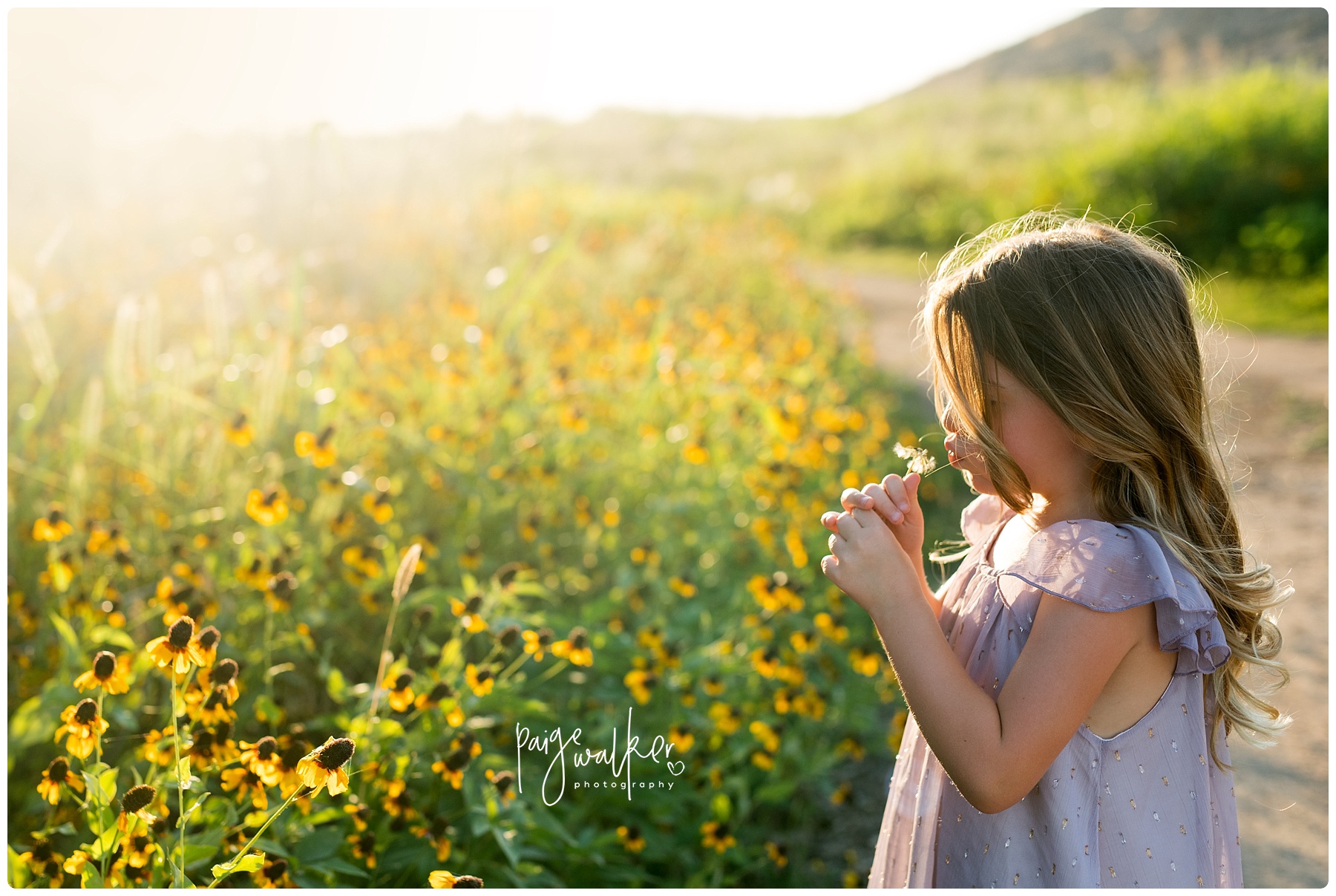 little girl blowing flowers