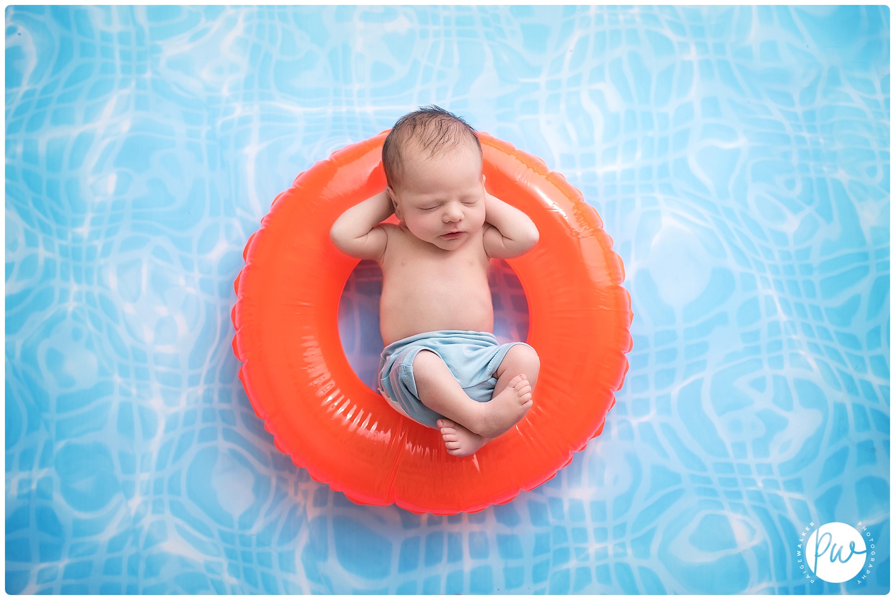 newborn boy relaxing on a pool float