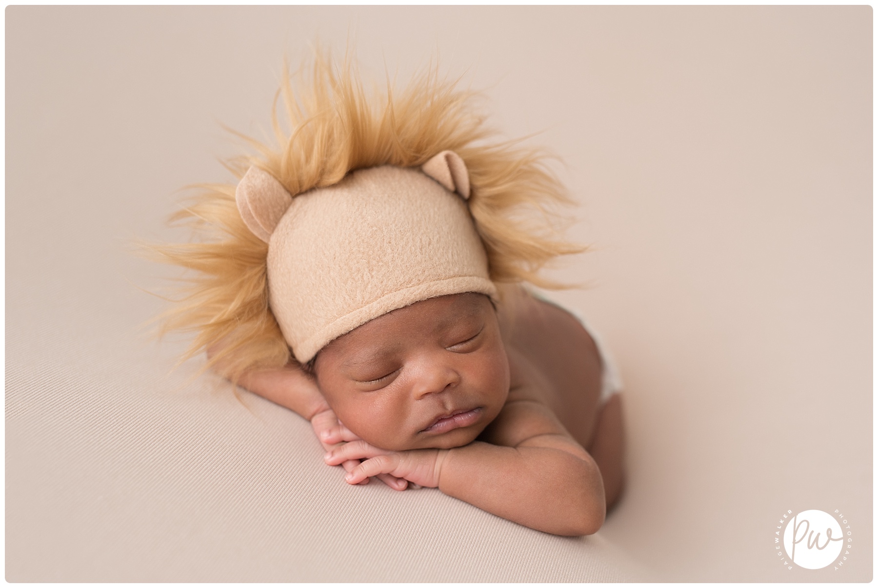 newborn boy wearing a lion hat