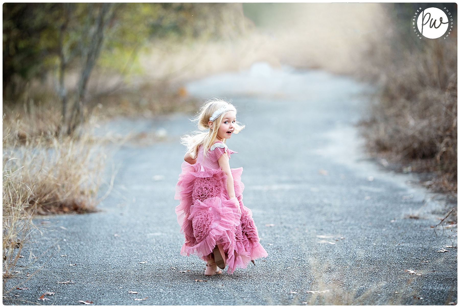 little girl running down a path