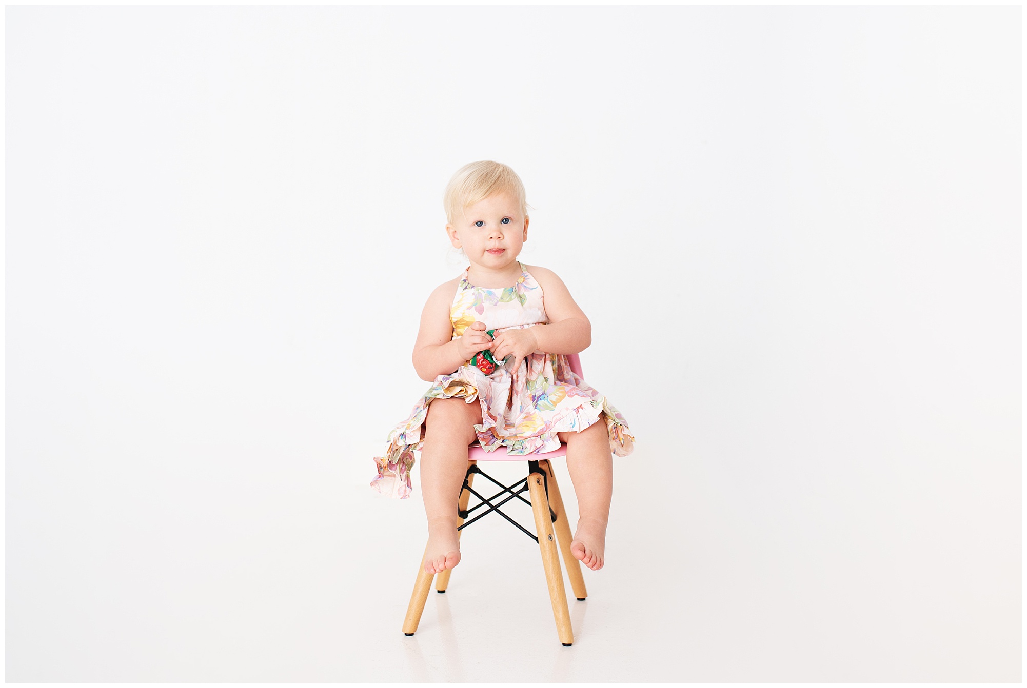 little girl sitting in a chair all by herself in the studio