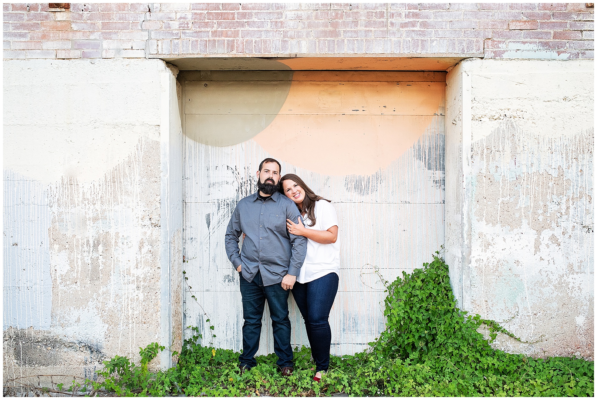 engaged couple standing in front of a painted concrete wall at an event venue BRIK 