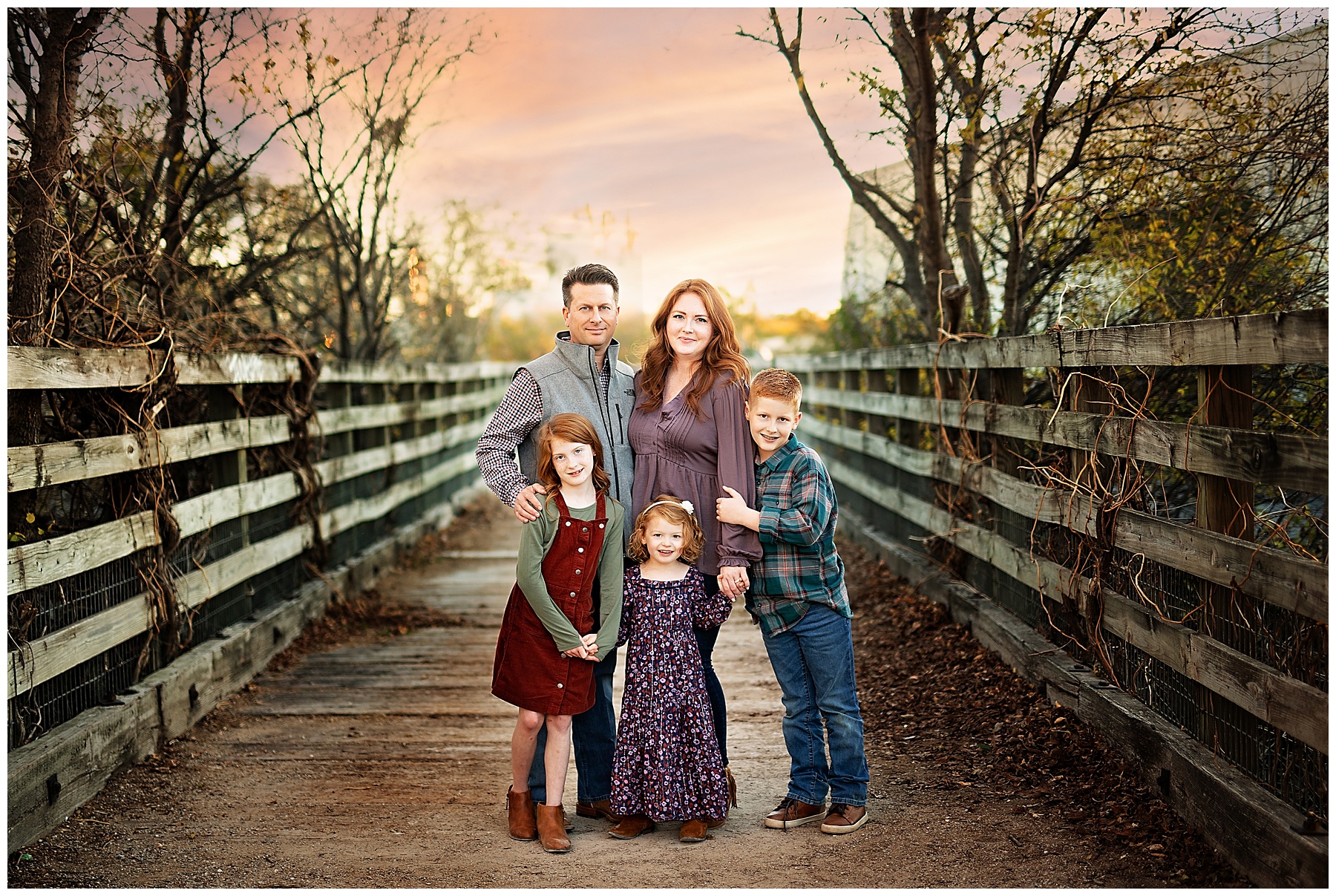 family of five standing on an old bridge in the Stockyards